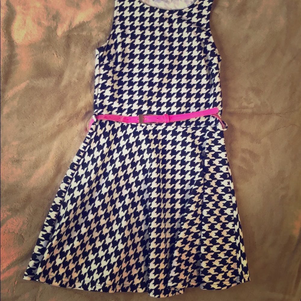 Black and white dress with pink belt.